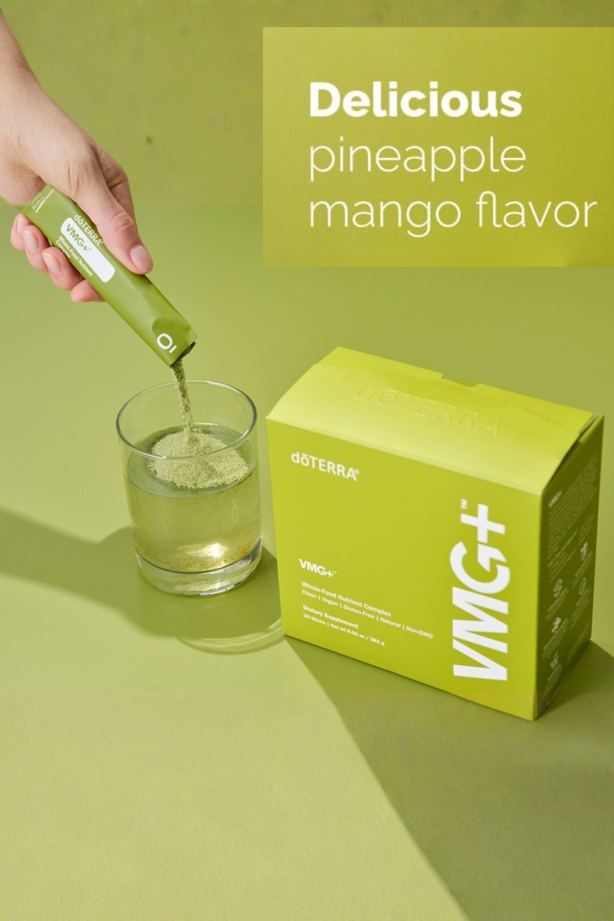 Hand pouring a green liquid into a glass with a VMG+ box on a green background
